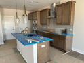 A kitchen island with granite countertops, ample storage, and modern light fixtures at 3022 White Rail Dr, Fuquay Varina, NC 27526