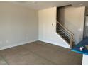 Open-concept living area with staircase and natural light at 3022 White Rail Dr, Fuquay Varina, NC 27526
