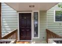 Front door of the house featuring unit number, window and wood trim at 304 Cedarwood Ln, Carrboro, NC 27510