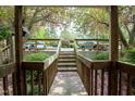 Exterior view of the property showing a wooden walkway and flowering trees at 304 Cedarwood Ln, Carrboro, NC 27510