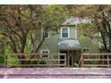 Charming exterior of the house with flowering trees and fence at 304 Cedarwood Ln, Carrboro, NC 27510