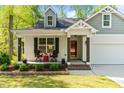 Inviting front porch features a cozy seating area, enhancing the home's curb appeal at 308 Thorndale Dr, Dunn, NC 28334