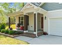 Charming covered porch with dark wood supports and brick platform for outdoor enjoyment at 308 Thorndale Dr, Dunn, NC 28334