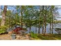 Relaxing patio area offering serene lake views surrounded by mature trees, making it a perfect outdoor retreat at 373 & 375 Sagamore Dr, Louisburg, NC 27549