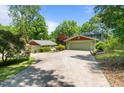 Long driveway leading to a two-car garage and a detached garage, offering ample parking space at 373 & 375 Sagamore Dr, Louisburg, NC 27549