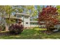 Spacious backyard featuring lush lawn, established garden beds, and mature trees at 373 Sagamore Dr, Louisburg, NC 27549