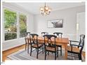 Elegant dining room featuring a wooden table, six chairs, and a large window at 4 N Poston Ct, Durham, NC 27705