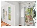 Bright entryway featuring hardwood floors, white trim, and views of the landscaped front yard at 4 N Poston Ct, Durham, NC 27705