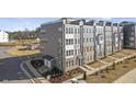 An attractive multi-story townhome with modern architectural details and manicured landscaping at 404 Gaston Park Ln # 100, Wake Forest, NC 27587
