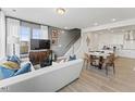 Bright, open-concept living room with a comfortable sofa, dining area, and modern kitchen at 404 Gaston Park Ln # 100, Wake Forest, NC 27587