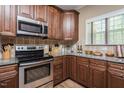 Bright kitchen featuring stainless steel appliances, granite counters, ample cabinet space, and wood flooring at 4057 Mackenzie Dr, Haw River, NC 27258