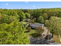 Aerial shot of a home nestled amongst a canopy of mature trees at 410 Long Ave, Roxboro, NC 27573