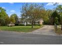 Well-maintained home featuring a long driveway and lush greenery at 410 Long Ave, Roxboro, NC 27573