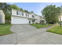 Attractive two-story house with a long drive, set against a backdrop of mature trees at 413 Weeping Willow Dr, Durham, NC 27704