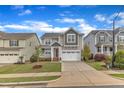 Inviting two-story house with manicured lawn, convenient garage, and charming front porch at 4252 Rockdell Hall St, Raleigh, NC 27616