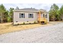 Attractive one-story house with a cozy front porch, tidy landscaping, and a well-maintained gravel driveway at 48 S Grace Way, Henderson, NC 27537