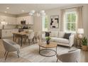 Bright, open-concept living area flowing into kitchen and dining, styled with modern furniture and natural light at 48 S Grace Way, Henderson, NC 27537