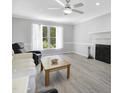 Inviting living room with a cozy fireplace, large window, and comfortable seating area at 5301 Night Heron Dr, Wake Forest, NC 27587