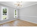 Bright and airy living room featuring two large windows offering ample natural light at 5301 Night Heron Dr, Wake Forest, NC 27587