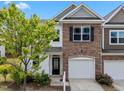 Attractive townhome with a stone-accented facade, attached garage, and a welcoming front entrance at 5518 Jessip St, Morrisville, NC 27560