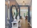Inviting entryway with geometric wallpaper, stylish mirror, and a view of the staircase and dining area at 6010 Grey Colt Way, Durham, NC 27703