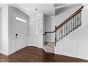 Bright foyer featuring hardwood floors, a staircase with decorative railings, and ample natural light at 6230 Pesta Ct, Raleigh, NC 27612