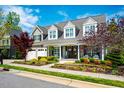 Beautiful home with manicured landscaping, a covered porch, and a three-car garage at 658 Bennett Mountain Trce, Chapel Hill, NC 27516