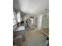 Eat-in kitchen with an island, older appliances, and light-colored cabinetry at 683 Osgood Rd, Sanford, NC 27330