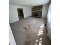 Bright living room with a brick fireplace and lots of natural light streaming in from a window at 683 Osgood Rd, Sanford, NC 27330