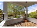 Lovely balcony with wood flooring, metal railing, and great view of the outside scenery at 703 Copperline Dr # 301, Chapel Hill, NC 27516