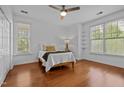 Bright bedroom with wood floors, ceiling fan, and natural light from multiple windows at 703 Copperline Dr # 301, Chapel Hill, NC 27516
