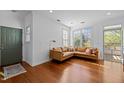 Inviting living room with a leather sectional sofa, wood floors and natural light streaming through the window at 703 Copperline Dr # 301, Chapel Hill, NC 27516