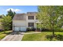 Inviting two-story home featuring a well-manicured lawn, a two-car garage, and a charming front entrance with classic design at 707 Southshore Pkwy, Durham, NC 27703