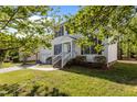 Inviting two-story home boasts a well-kept lawn, a two-car garage, and a charming front entrance enhanced by lush landscaping at 707 Southshore Pkwy, Durham, NC 27703
