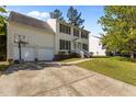 Charming two-story home boasts a two-car garage, complemented by a well-maintained lawn and inviting front entrance at 707 Southshore Pkwy, Durham, NC 27703