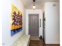 Bright entryway featuring hardwood floors, art and a stylish bench seating at 713 Macon Pl, Raleigh, NC 27609