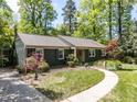 Attractive exterior featuring a winding walkway leading to a charming single-story home at 713 Macon Pl, Raleigh, NC 27609