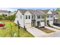 Beautiful townhouse showcasing a driveway, single-car garage, and manicured lawn with small shrubs at 72 S Grey Abbey Dr, Clayton, NC 27527