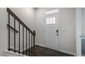 Bright entryway features a white front door with glass and dark wood-look flooring at 766 Dorset Stream Dr, Fuquay Varina, NC 27526