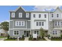 Modern townhome featuring multi-tone siding, a welcoming entrance, and professional landscaping at 768 Dorset Stream Dr, Fuquay Varina, NC 27526