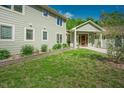 Gorgeous home showcasing the well-maintained lawn, sage siding, and mature landscaping at 7955 Midnight Ln, Wake Forest, NC 27587
