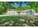 A serene exterior showcasing an idyllic home nestled among lush greenery, offering a peaceful and private setting at 7955 Midnight Ln, Wake Forest, NC 27587