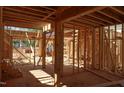 The house framing shows interior wood stud walls and support beams detail of new home construction at 7961 Wexford Waters Ln, Wake Forest, NC 27587