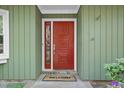 Close up of front door with decorative accents and a sidelight at 8 Bluebell Ct, Durham, NC 27713