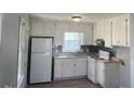Cozy kitchen features white cabinets, modern appliances, and lots of light at 801 E Highland Ave, Rocky Mount, NC 27801