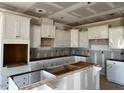 Spacious kitchen features white cabinets, granite countertops, and a large center island at 871 Olive Branch Dr, Smithfield, NC 27577