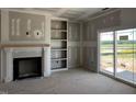 Living room shows fireplace, built-in shelves, and sliding glass doors leading to the backyard at 871 Olive Branch Dr, Smithfield, NC 27577