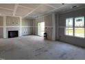 Spacious living room featuring an elegant fireplace and a sliding glass door leading to the outside at 871 Olive Branch Dr, Smithfield, NC 27577