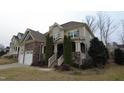 Charming two-story home with stone accents, attached garage, and well-maintained landscaping at 901 Hollymont Dr, Holly Springs, NC 27540