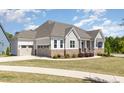 Attractive home featuring a three-car garage and appealing exterior design with stone accents at 101 Becklow Ridge Lane Ln, Holly Springs, NC 27540